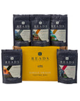 A coffee tasting box set by Reads Coffee Roastery, featuring a central yellow box surrounded by five dark blue single-origin coffee pouches, including Colombia, El Salado, Sumatra, Kenya AA, and India.