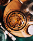 Close-up of a coffee filter with brewed coffee and grounds.