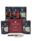 Reads Coffee Roasters Coffee Box gift set featuring a red cardboard box in the center, surrounded by five dark navy coffee bean bags in different flavors, with two small cards in front, on a white background.