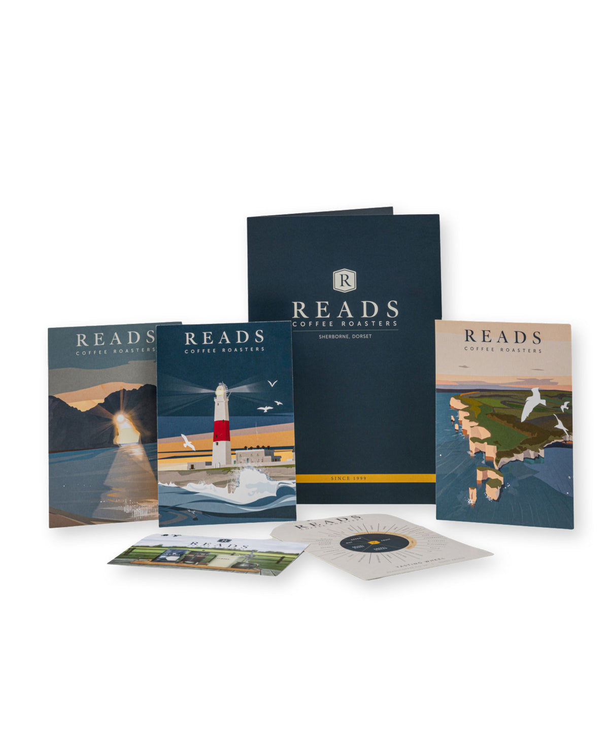 A set of Reads Coffee Roasters printed materials and packaging displayed on a white background, including a large navy folder, smaller printed cards, and a circular insert with a lighthouse and coastal artwork.
