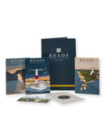 A set of Reads Coffee Roasters printed materials and packaging displayed on a white background, including a large navy folder, smaller printed cards, and a circular insert with a lighthouse and coastal artwork.