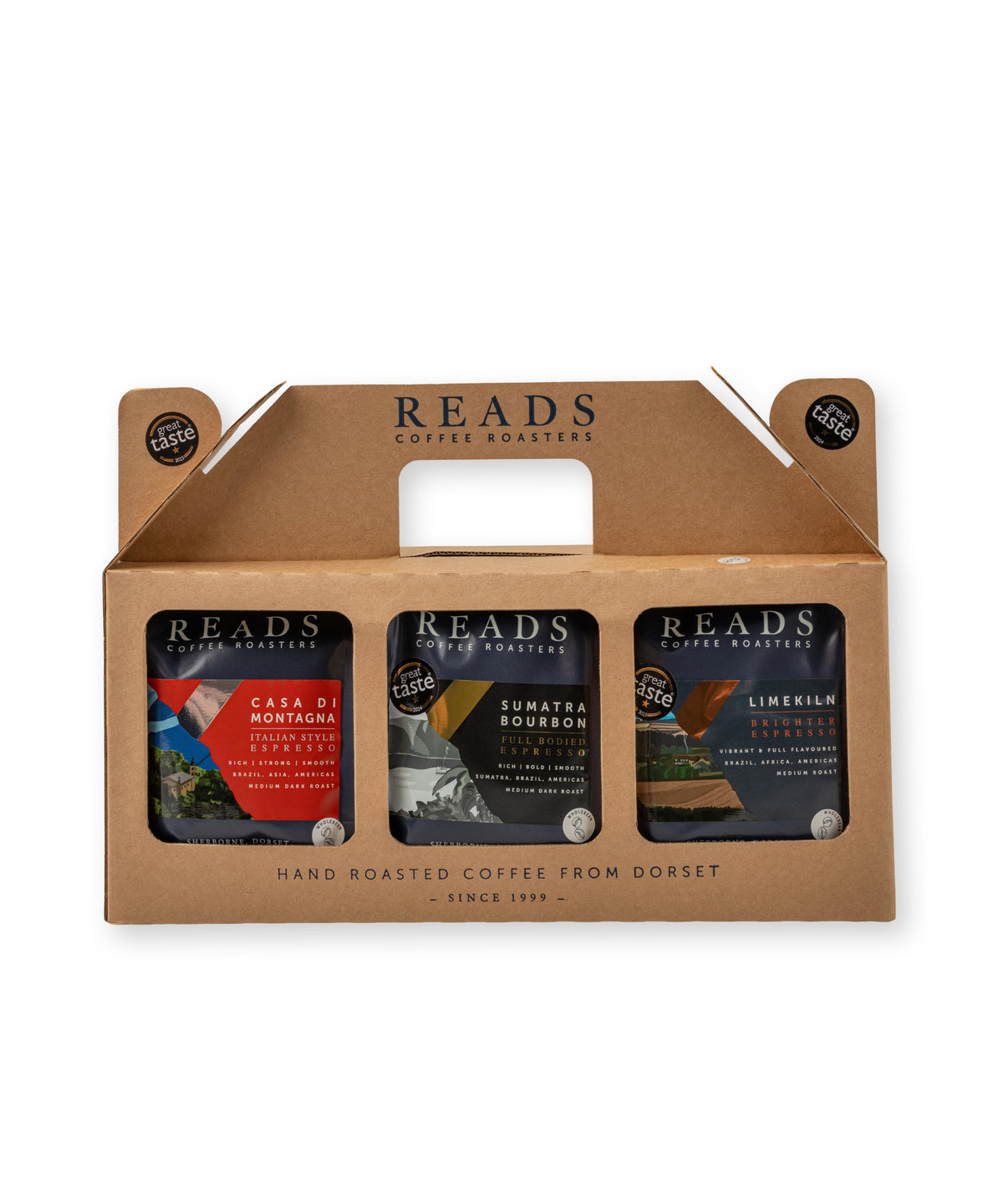 A 3-pack of Reads Coffee Roasters in a brown cardboard carrier box. The three individual coffee bags are visible through clear windows at the bottom of the box, featuring red, yellow, and dark black labels.
