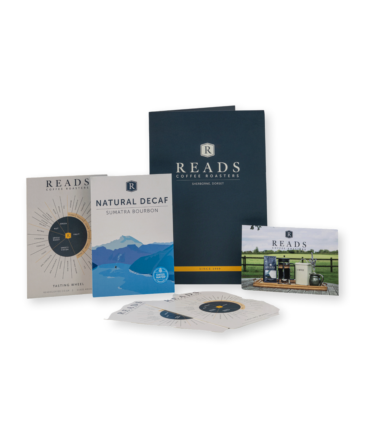 A coffee roasting education kit by Reads Coffee Roasters on a white background, including a navy guidebook, a tasting notes booklet, a flavor profile card, a small photo card, and several vinyl record sleeves.