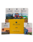 A Reads Single Origin Tasting Box set featuring a central yellow box surrounded by five single-origin sample cards: Colombia, Americas, Indonesia, Africa, and India, arranged on a white background.