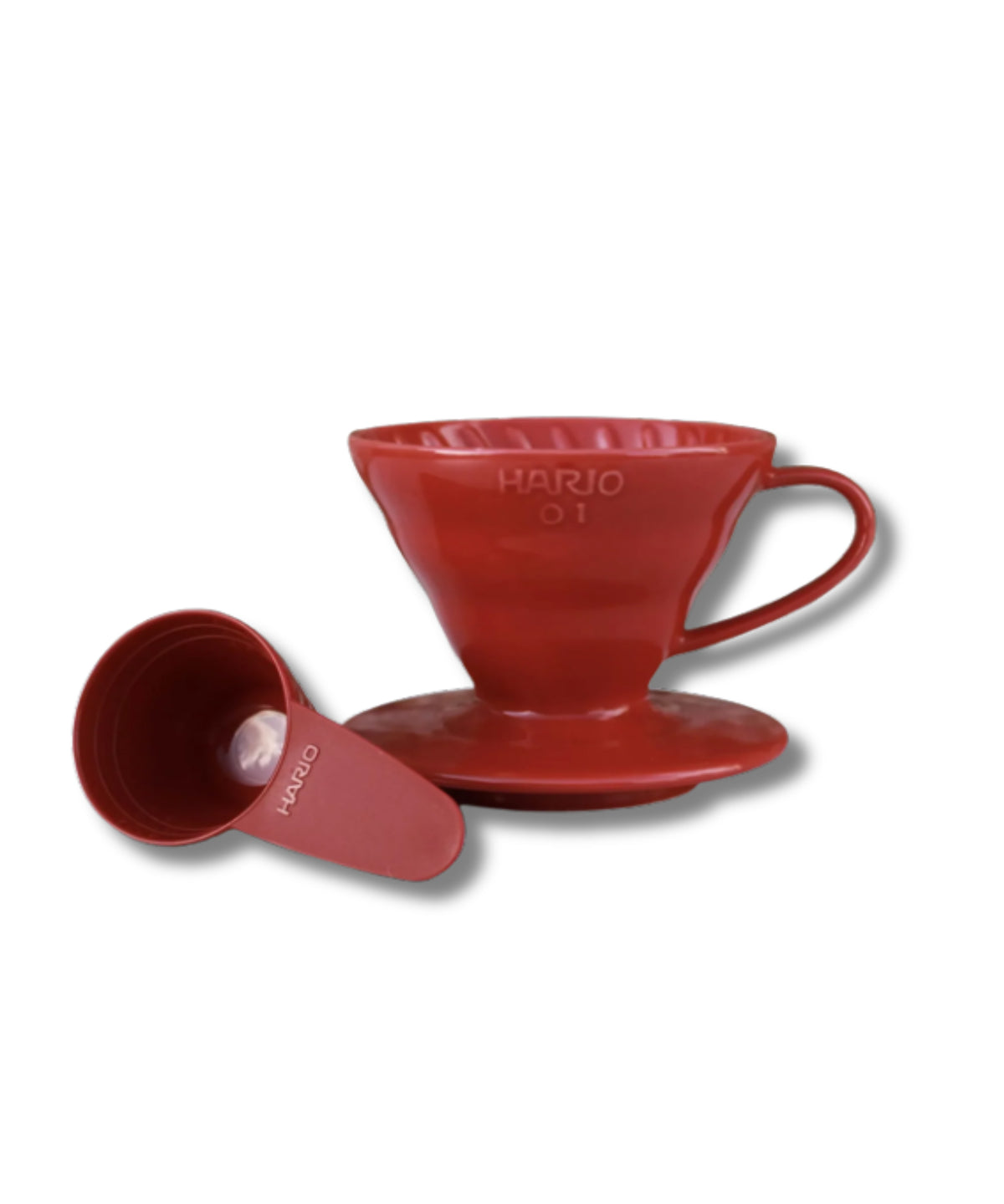 A red Hario V60 pour-over coffee dripper with its matching saucer and small measuring scoop, shown on a clean white background.