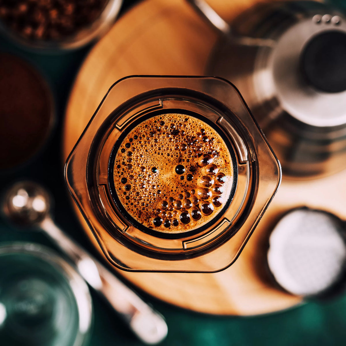 Close-up of a coffee filter with brewed coffee and grounds.