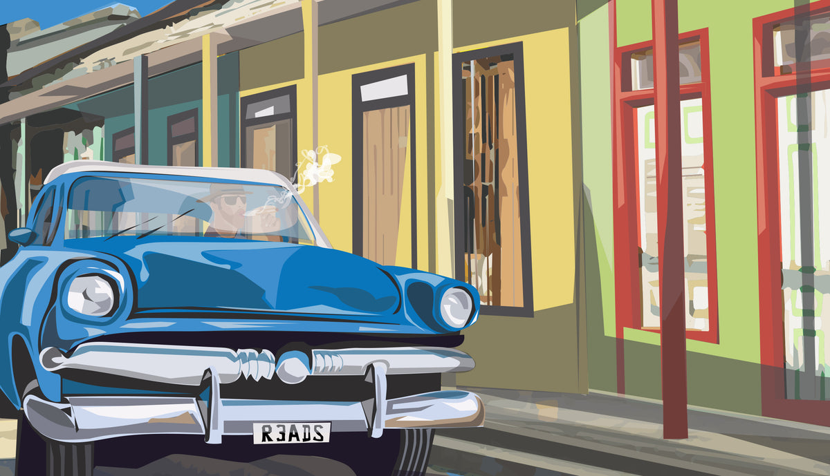 Blue vintage car parked in front of a colorful building